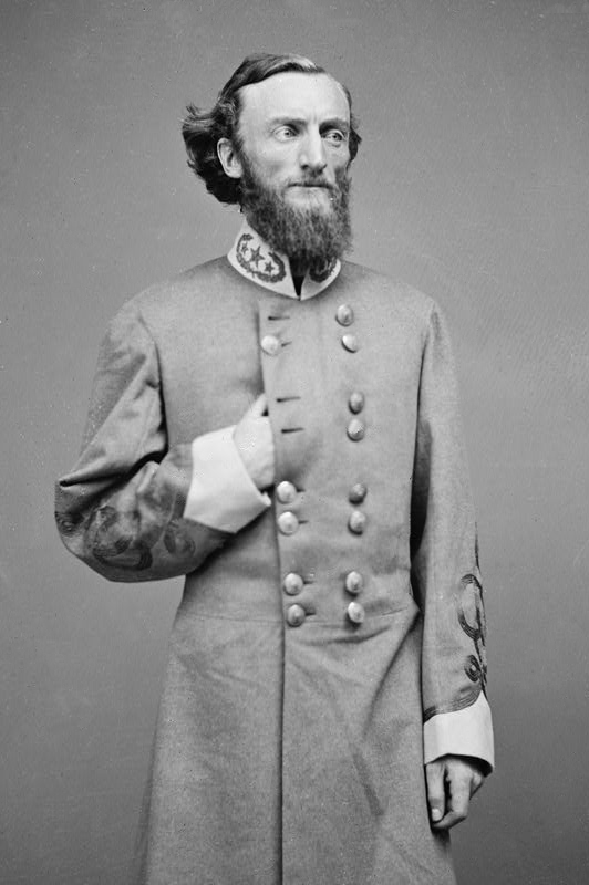 Key Player - Confederate General John S. Marmaduke portrait, 1860s photograph, in military uniform with long beard and hand tucked in coat.